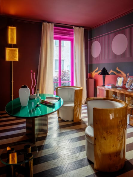Plush colours and black and white stripes on the floor in the sitting room.