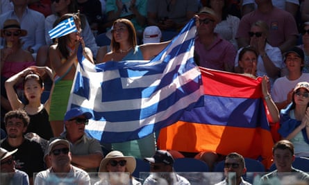 A spectator inside the Rod Laver Arena holds up the Greek flag in a show of support for Stefanos Tsitsipas during his semi final