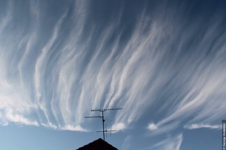 Cirrus uncinus clouds above a rooftop in England.