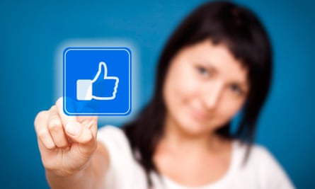 Woman is touching the Facebook like button.