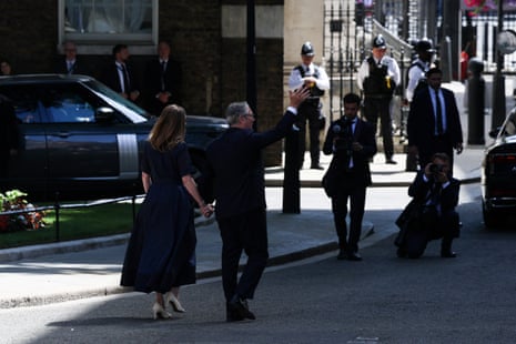 British prime minister Keir Starmer greets members of the media as he and his wife, Victoria Starmer, walk to their car, after Starmer delivered his final statement outside 10 Downing Street.