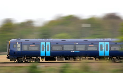 a light blue and dark blue liveried southeastern train