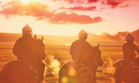 Exercising horses on the gallops in Newmarket at sunrise