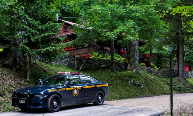 A New York State Trooper stands guard outside the home where Roy Den Hollander was found dead after allegedly killing the son of federal judge Esther Salas.