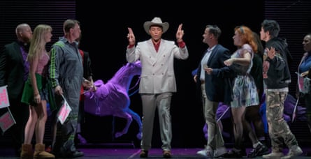 The cast of new opera The Galloping Cure, with singer Justin Austin, playing Mack, in a white suit and stetson hat standing in the middle of a line of performers.