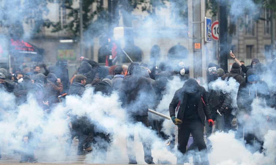 Masked men clash with riot police during a demonstration against labour reforms in Nantes, western France.