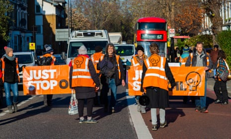 Just Stop Oil activists stage a go-slow protest disrupting traffic in Stoke Newington north London in December