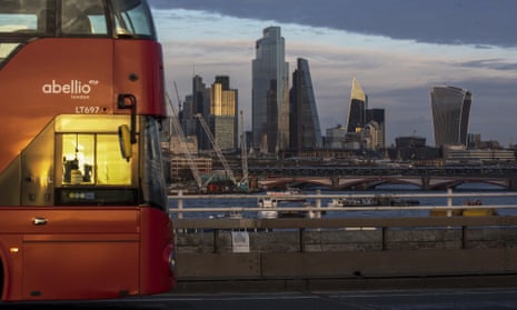 A London bus crosses Waterloo bridge against a backdrop of skyscrapers, including 22 Bishopsgate office tower, in City of London