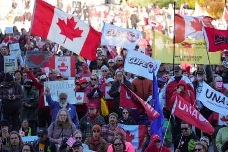 people hold signs and wave flags