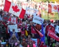 people hold signs and wave flags