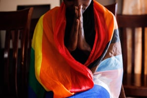 A member of the LGBTQ community prays during the evangelical church service in Kampala