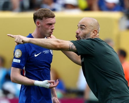 Chelsea manager Enzo Maresca makes an animated gesture while explaining a point to Cole Palmer.