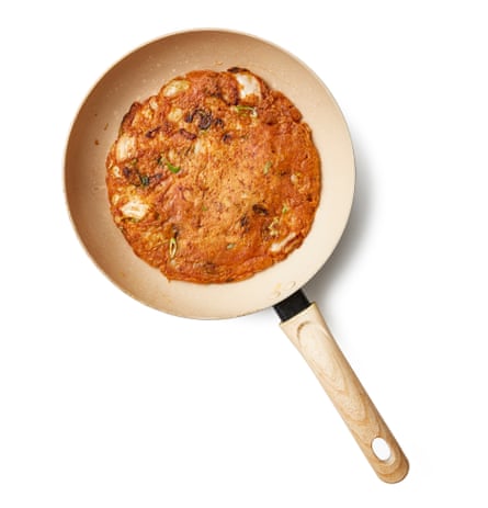 Carefully flip pancake over, by using a spatula or a plate, or by tossing the pancake depending on if your level of confidence is high, then lift it slightly and tilt the pan again to move the oil about underneath it – add more if there isn’t much left in the pan. Cook for another three or so minutes, until golden and crisp (repeat with the remaining batter, if making two smaller pancakes). Slide on to a board or plate, cut into wedges and eat immediately.