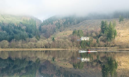 a kayaker reflected in the still water of Loch Lubnaig