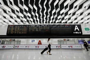 Women wearing protective face masks walk past the arrival zone at Narita International Airport, where there are fewer passengers than usual amid the coronavirus outbreak, in Narita, east of Tokyo, Japan, on 2 November, 2020.