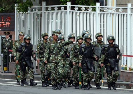 Paramilitary police patrol a street in Urumqi in Xinjiang in 2014.