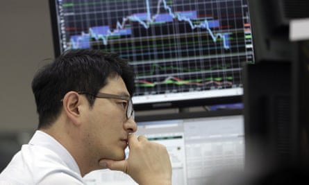 A South Korean currency trader watches monitors during September’s Asian stock sell-off.