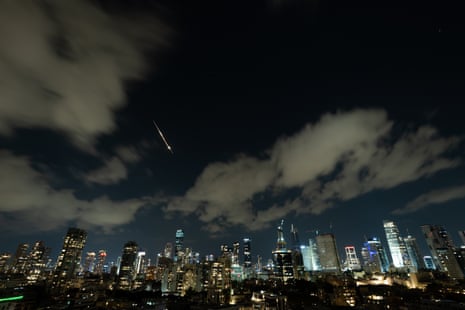 A projectile streaks over the Tel Aviv night skyline