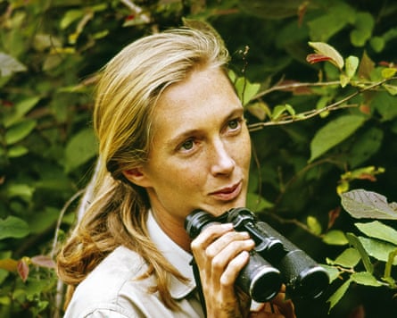 Jane Goodall holding binoculars in a closeup shot in the jungle