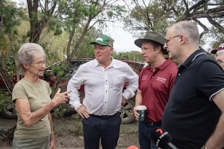 Steven Miles and Anthony Albanese speak with a Holloways Beach resident after flooding in north Queensland