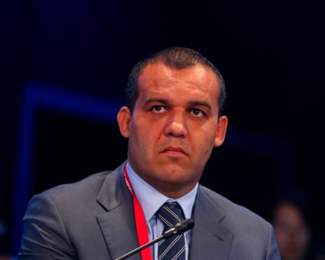 A man in a suit frowns