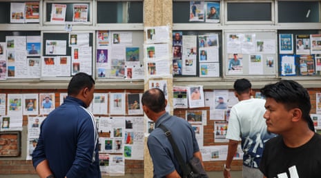 A wall posted with photos of missing people outside a hospital in the capital city, in Kathmandu, Nepal.