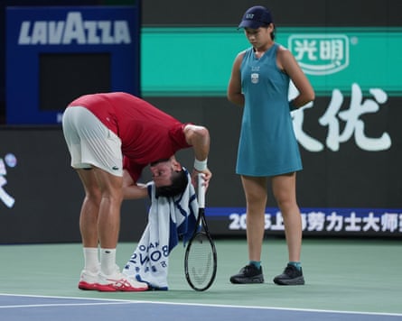 Novak Djokovic towels away sweat