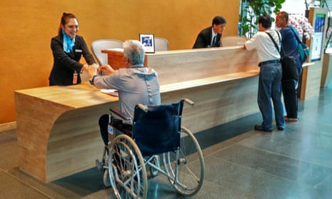 The reception area of the CapitaGreen building has a lowered front desk. The building has won numerous accessible design awards.