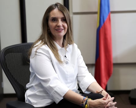 Paloma Valencia sitting next to a flag
