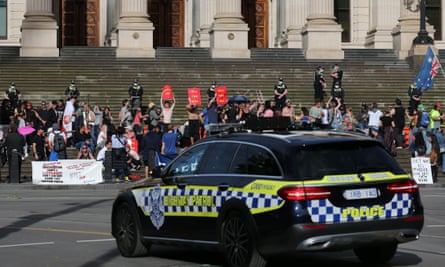 Protesters raging against pandemic laws on the steps of the Victorian parliament.