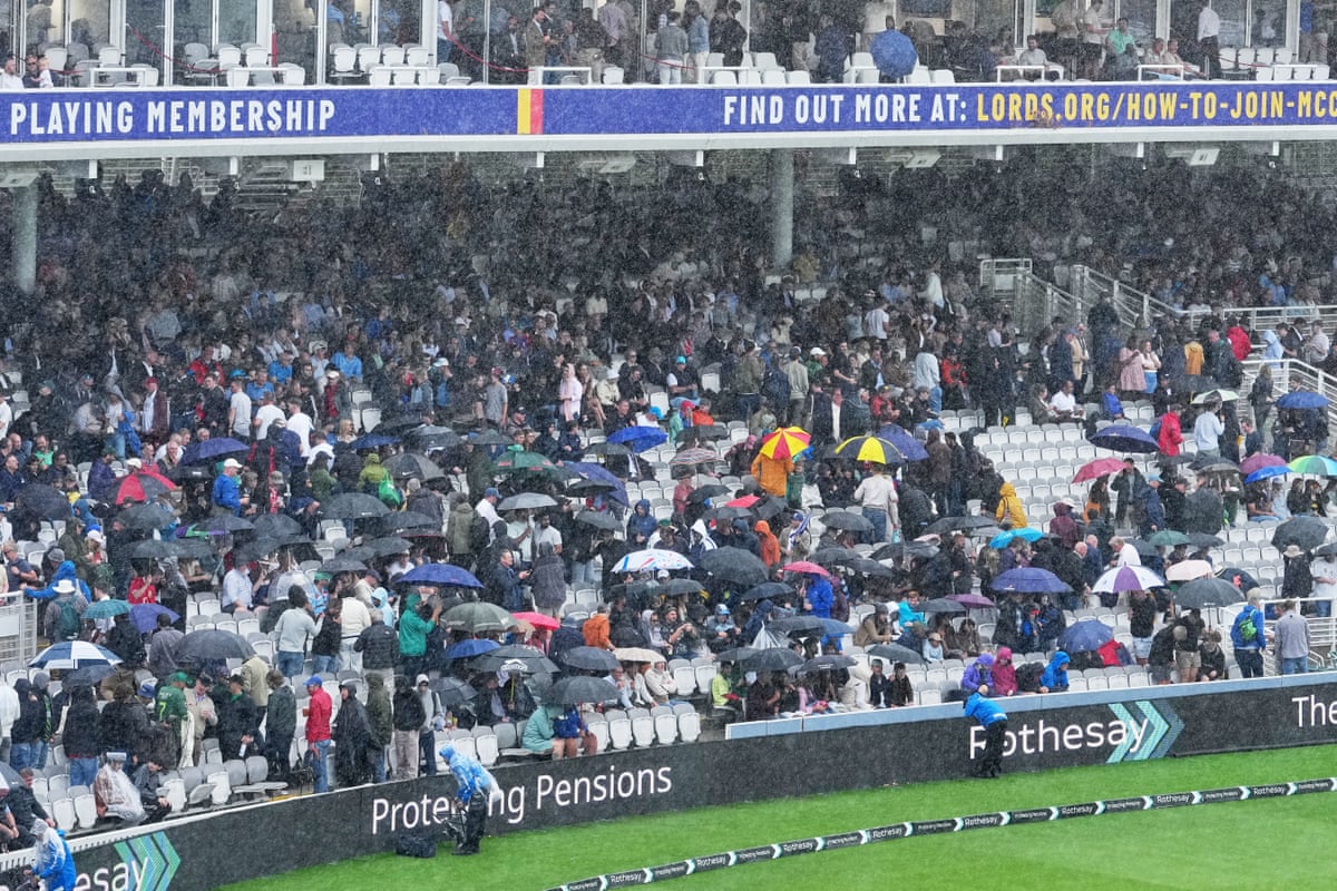 Rain falls on spectators at Lord’s