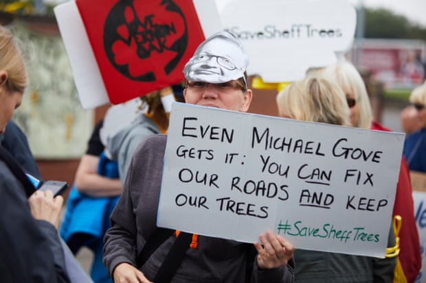 A placard cites Michael Gove.
