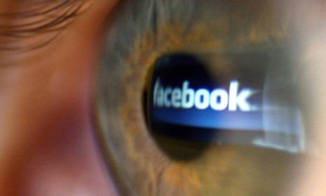 The Facebook logo reflected in a person’s eye