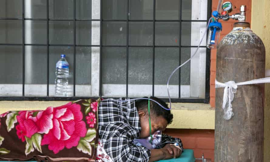 A Covid patient receives oxygen as he lies on a bed outside an emergency ward of a hospital in Kathmandu, Nepal on Friday.
