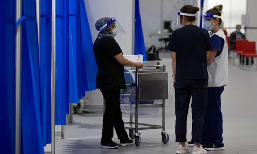 Vaccination staff inside the Melbourne Convention and Exhibition Centre. An Australia Institute poll has found most Australians are on board with mandatory Covid vaccines for frontline workers who work with vulnerable groups.