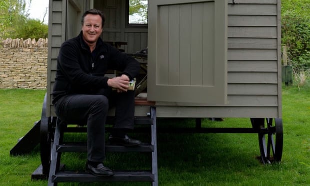 David Cameron relaxes on the steps of his £25,000 luxury garden hut.