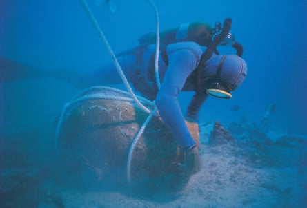A scuba diver salvaging a cask underwater