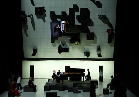 Igor Levit sat at a piano, reflected in a mirrored ceiling