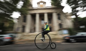 A woman on a penny farthing