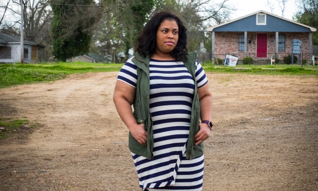Angie Thomas standing on land in front of her house
