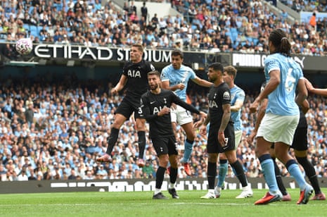 Manchester City's Rodri heads at goal.