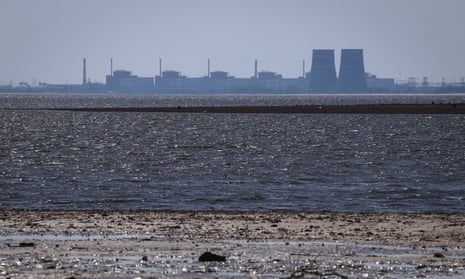 The Zaporizhzhia nuclear power plant, Europe's largest, is seen in the background of the shallow Kakhovka Reservoir after the dam collapse