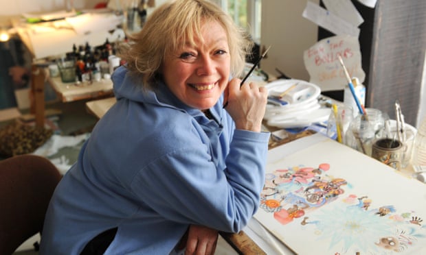 Babette Cole smiling at desk with illustration