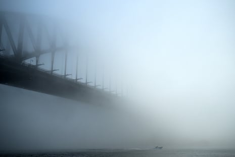 A bridge partially seen in heavy fog.