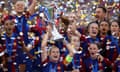 Barcelona's Alexia Putellas lifts the trophy as she celebrates with teammates after winning the Champions League final against Lyon.