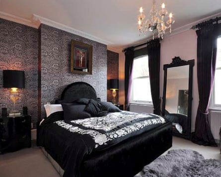 Gothic-style bedroom in Russell Brand's townhouse, with black bed and ornate mirror