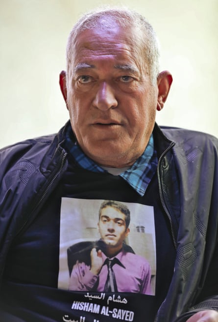 Sha'aban al Sayed, the father of Hisham al Sayed, displays a photo of his son.