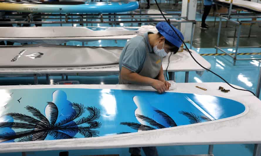 A worker on the production line for surfboards in Binzhou, China.