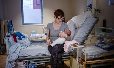 Rebecca Dibb-Simkin and her daughter Eliza bond after her water birth. Photograph: Sarah Lee for the Guardian