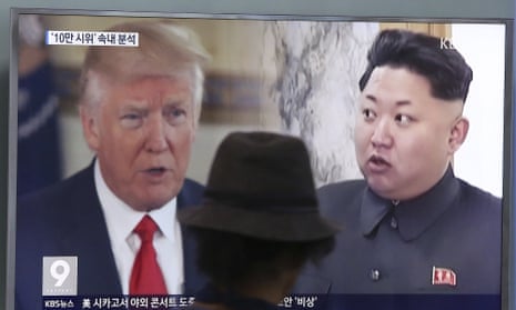 A man in Seoul watches a television screen showing Donald Trump and Kim Jong-un.